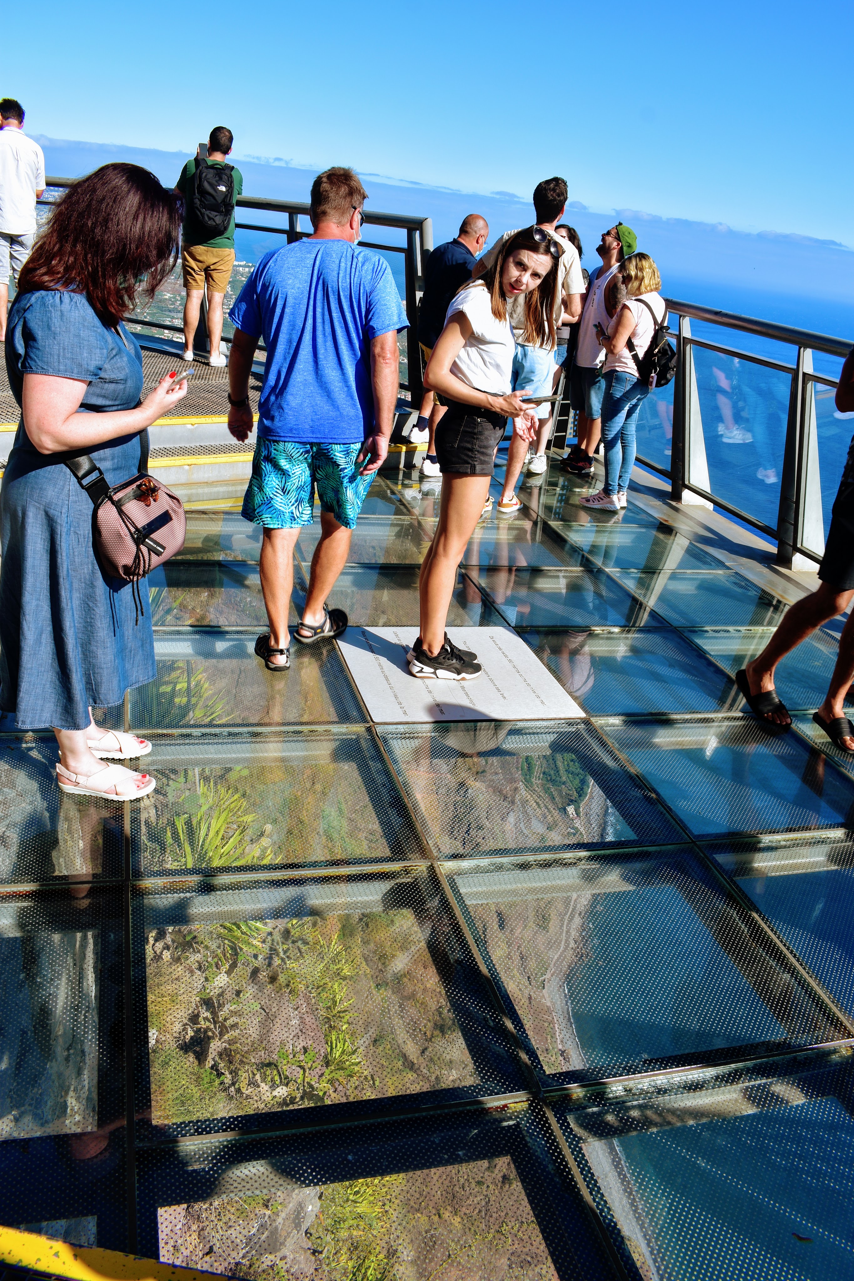 people standing on the glass walk at cabo girao