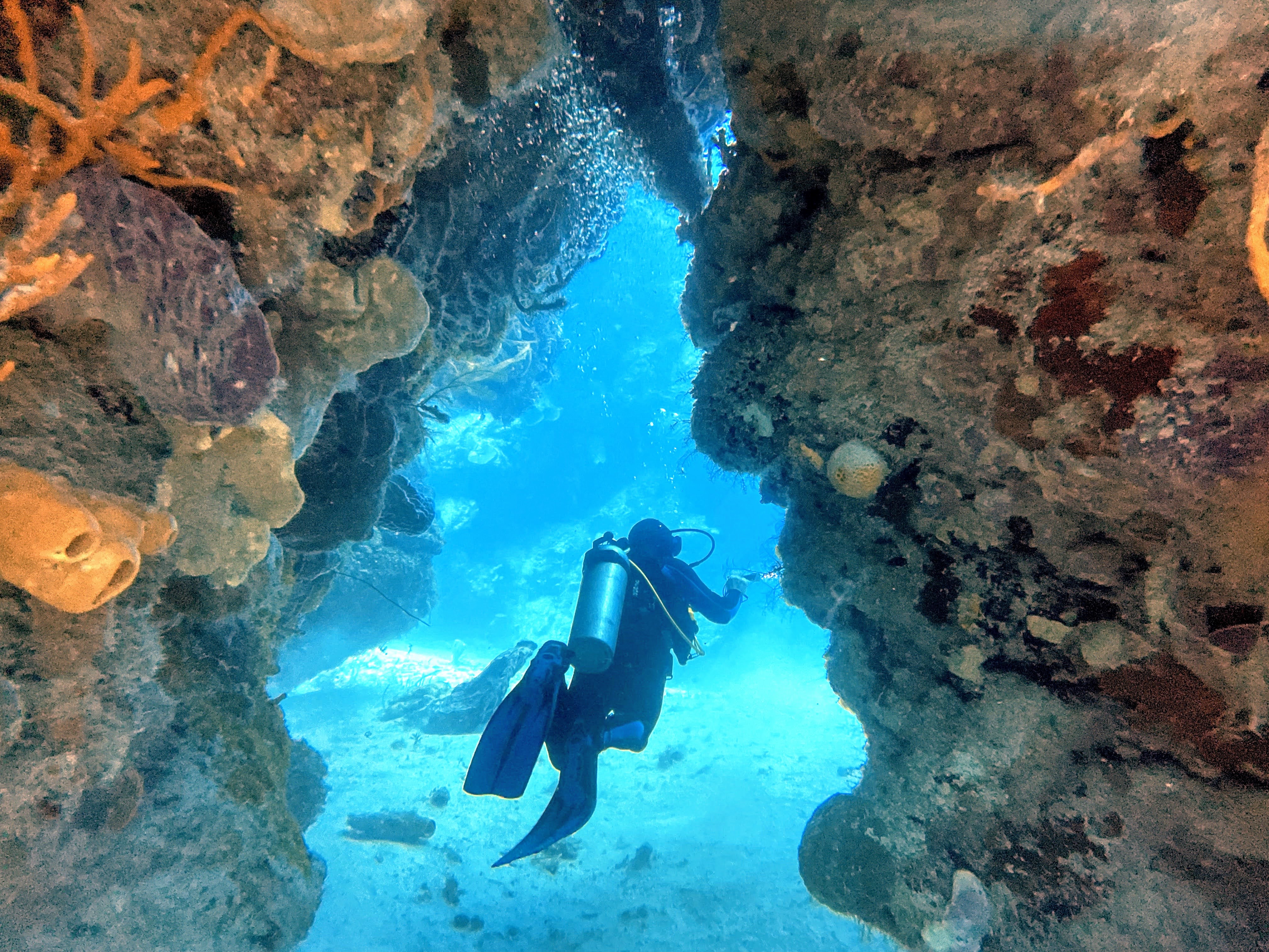 diver going through cave